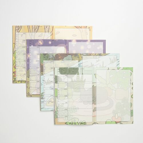 A Lana & Tuxedo Cat spread uses soft pink, purple, and blue tones with oversized cat illustrations beneath the planning grid.