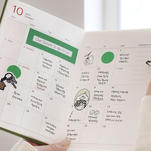 A filled daily page shows notes, checkmarks, stickers, and small illustrated accents across the lined schedule.