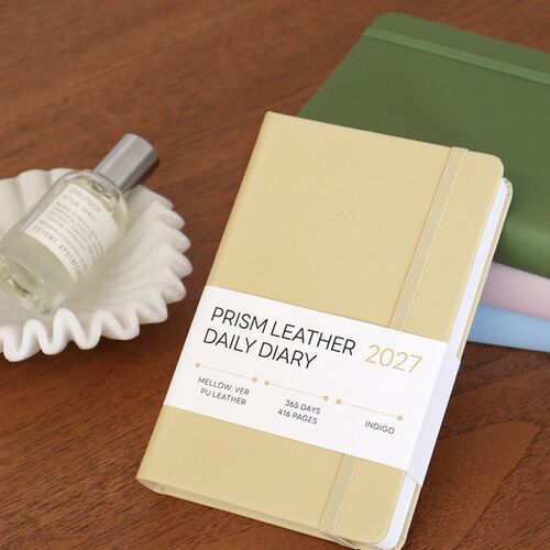 Several planners are arranged in a tall stack, making the rounded corners and varied cover colors easy to compare.