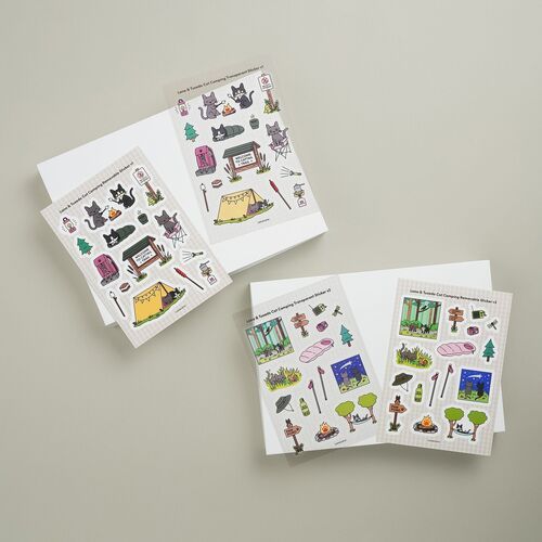 The v1 sheets feature Lana and Tuxedo Cat beside tents, campfires, trail signs, trees, and cozy outdoor gear.