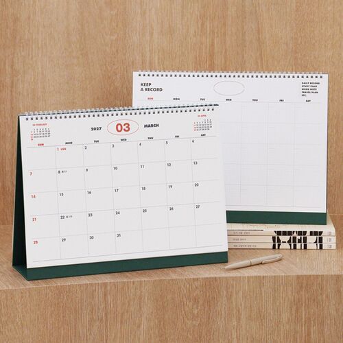 The calendar is shown open to a dated monthly spread with adjacent-month references and a spacious Sunday-to-Saturday grid.