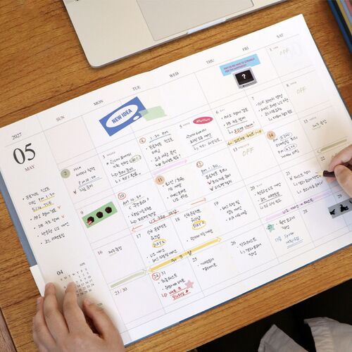 A May spread demonstrates how stickers, highlights, and handwritten notes can be added to the spacious monthly boxes.