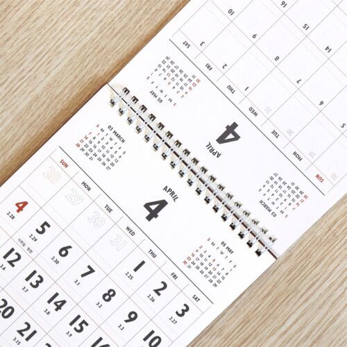 An open spread presents April and May grids with smaller neighboring month references for quick date checking.