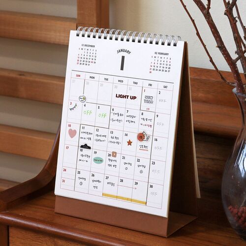 A December spread shows handwritten notes, colorful stickers, and marked dates across the spacious monthly boxes.