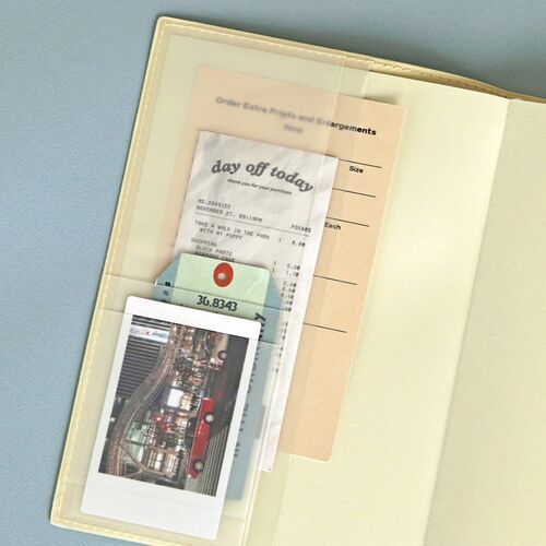An open planner shows a yearly overview with compact monthly calendars and lined space for notes underneath.