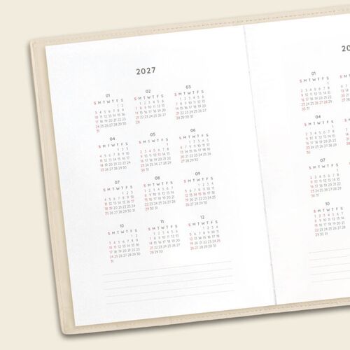 Open pages reveal graph paper-style note sections that work well for lists, planning ideas, and personal records.
