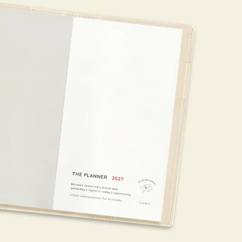 The open Butter planner displays a practical checklist-style page with a loose photo tucked inside.