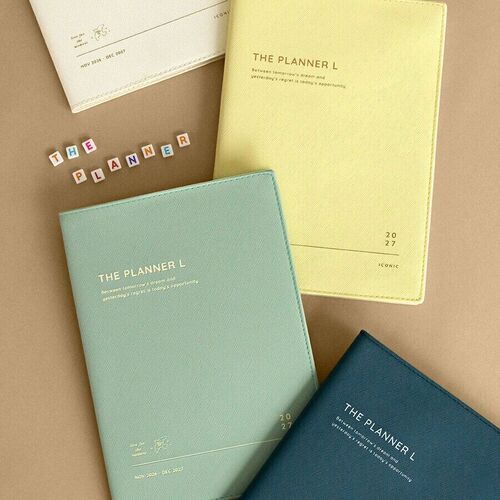 The Cream planner is photographed with Lemon Yellow and Mint versions, showing the coordinated color range and book-like shape.