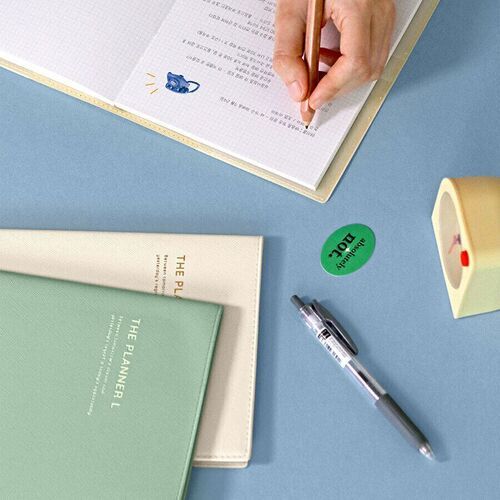 Handwritten notes and small pictures fill a grid page, demonstrating space for journaling, records, and visual details.