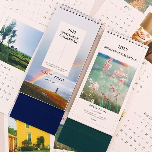 A close tabletop arrangement compares Flower and Rainbow covers alongside individual pages from the photo-inspired monthly collection.