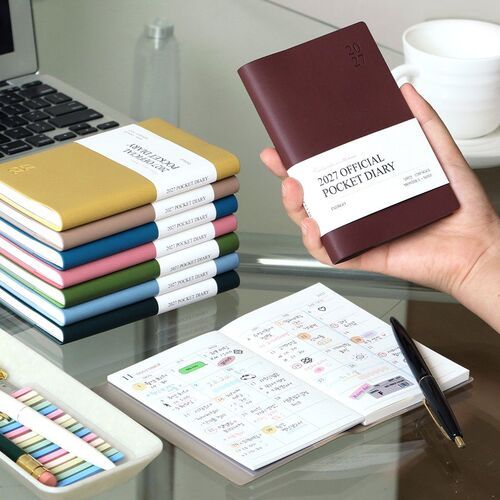 Red Bean is held beside a laptop, while a monthly spread below shows the planner in an organized workspace.