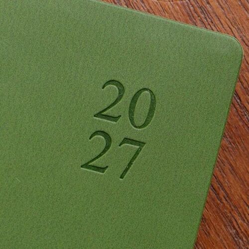 The Green Mousse cover is shown in close detail, including its softly textured PU surface and debossed year mark.