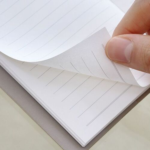 The center binding lies flat across a wooden surface, showing the planner’s neatly assembled page block.