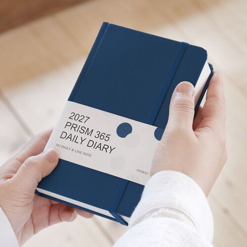 Several planners are stacked horizontally to show the thickness of the 400-page format and the sturdy hardcover construction.