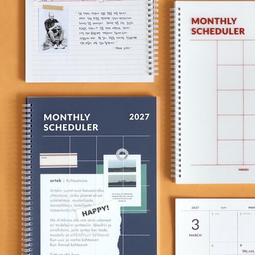 The open White planner displays lined writing space beside its spiral binding, while the Navy cover shows the matching design.