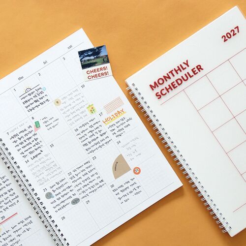 A lined notes spread offers broad writing space with a printed measurement guide visible at the lower right.
