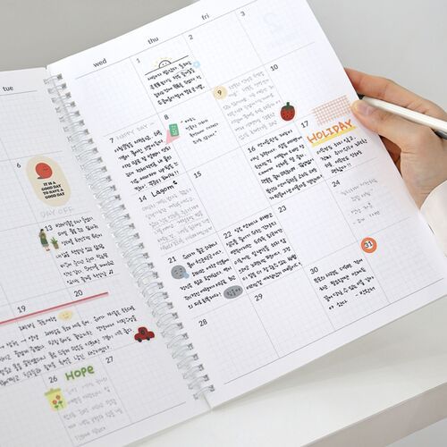 A monthly spread is filled with handwritten entries, stickers, and small illustrations to demonstrate flexible note space.