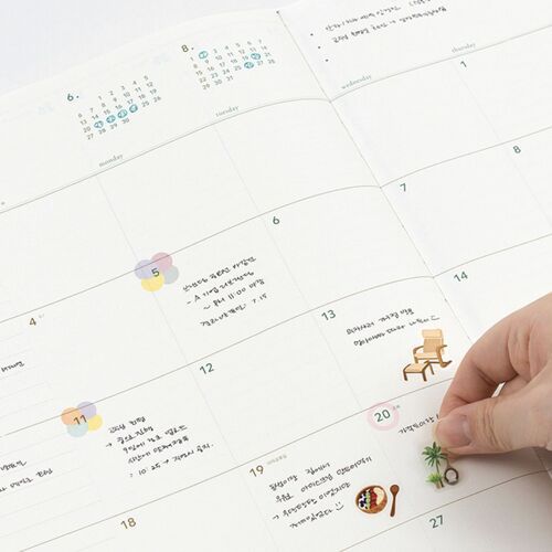 A wide July 2027 spread shows weekday columns, reference calendars, and handwritten planning examples.