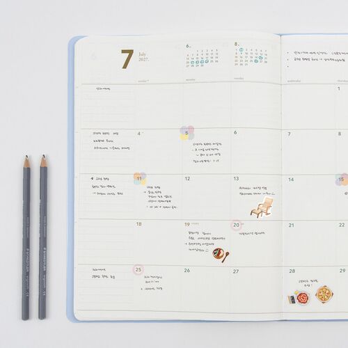 The Ice Blue planner is open to a spacious July 2027 weekly layout with room for notes and appointments.