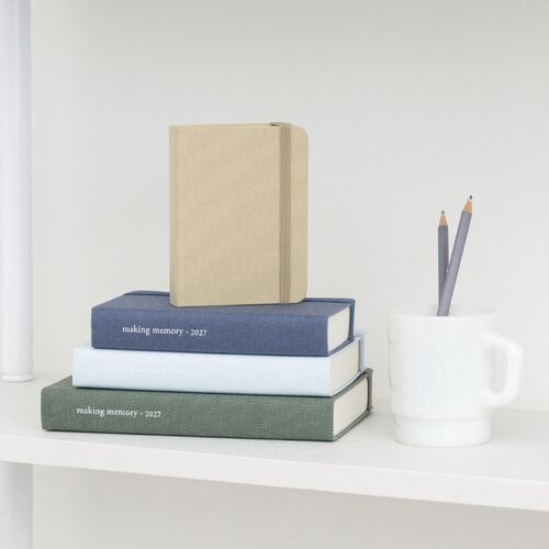 Muted Pink planners in multiple sizes are arranged together, emphasizing the color range and rounded hardcover profile.