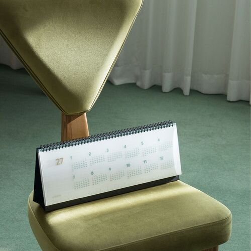 Different standing formats are shown together, highlighting the calendar’s horizontal layout and compact desk presentation.