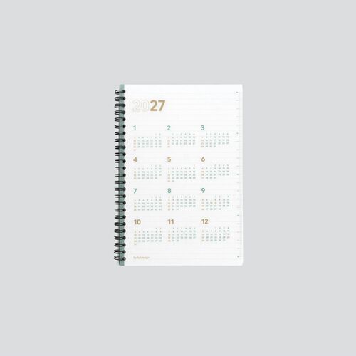 The closed planner displays all twelve numbered 2027 months with mint and gold accents across the front page.