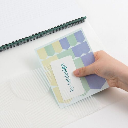 A detail shot pairs the planner with a metric ruler strip and month tabs, showing the cover’s measurement markings.