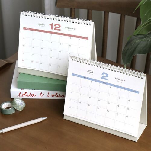 A December calendar page and February page are displayed together, highlighting the clean grid layouts and soft blue and coral accents.