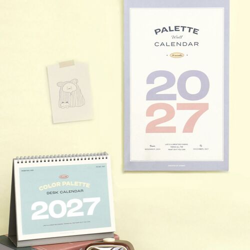 A November 2026 page sits on a bedside table, introducing the calendar’s early starting month with pink accents.
