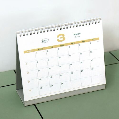 The freestanding desk format is shown from an angled view with a March monthly page and a sturdy folded base.