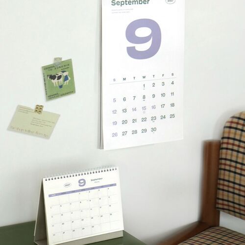 The August calendar rests beside a vintage radio and plant, bringing the palette design into a styled tabletop setting.