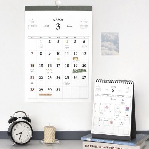 A handwritten August page demonstrates how the open calendar grid accommodates colorful notes, stickers, and personal plans.