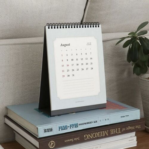 The March wall calendar and August desk scheduler illustrate the uncluttered monthly layout in use.