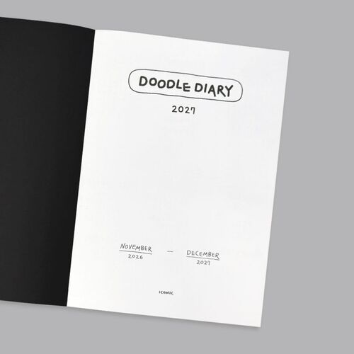 The White planner is shown with a pen tucked into its side holder, emphasizing the convenient writing setup.