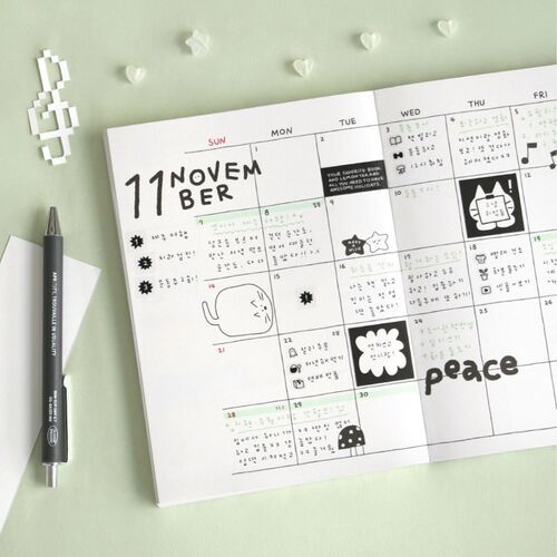 The planner’s monthly review layout gives organized boxes for tracking activities, media, food, places, and memories.