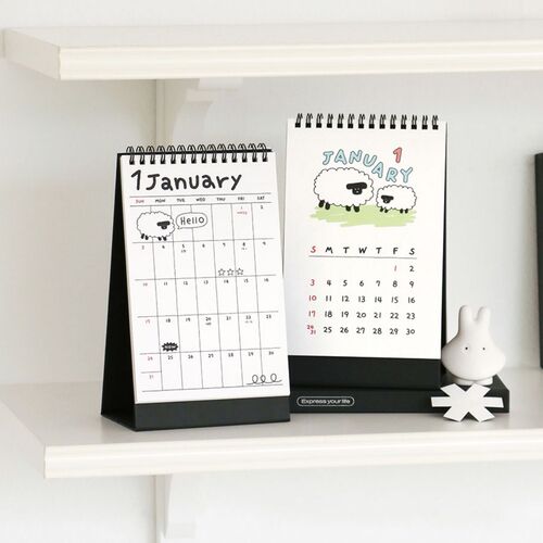 Photo 8: Two standing calendars show January pages, including sheep artwork, weekday headings, and open spaces for notes.