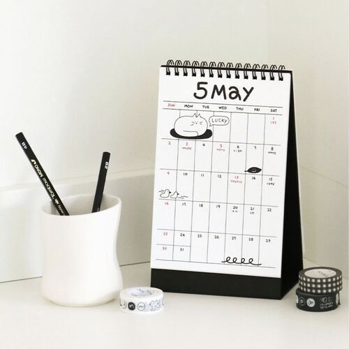 Photo 12: A close view of May shows the spiral top, handwritten-style numerals, and a large grid for recording plans.