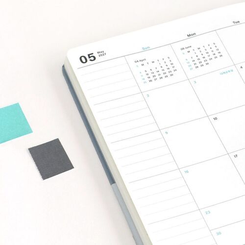 An open monthly spread shows a clear calendar grid with mint accents and generous writing space for planning.