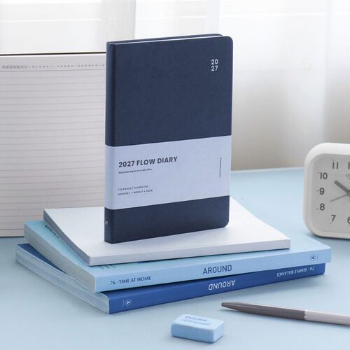 Navy stands upright on stacked books, showing the deep cover color and wide white information band.