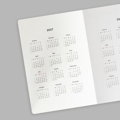 Multiple covers are arranged around an open calendar page to show the range of available colors and coordinated design.