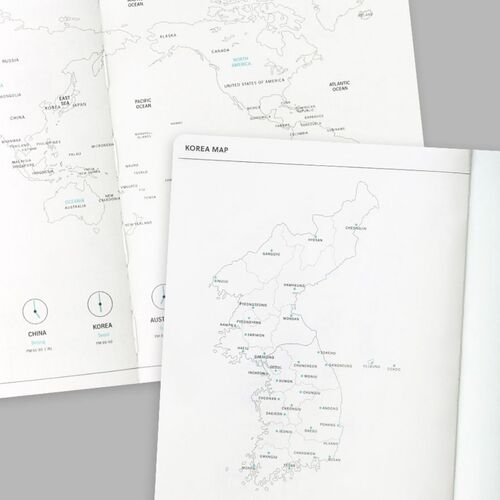 An open monthly spread is shown beside stacked planners, giving a sense of the book’s page thickness and format.