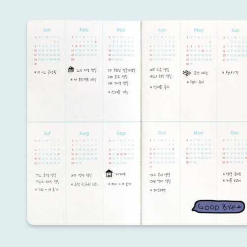 The Moments planners are stacked together, revealing rounded corners and the thickness of the page block.