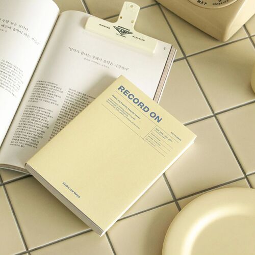 Serenity Blue planner is displayed upright beside its matching spine, highlighting the clean cover layout and compact B6 shape.