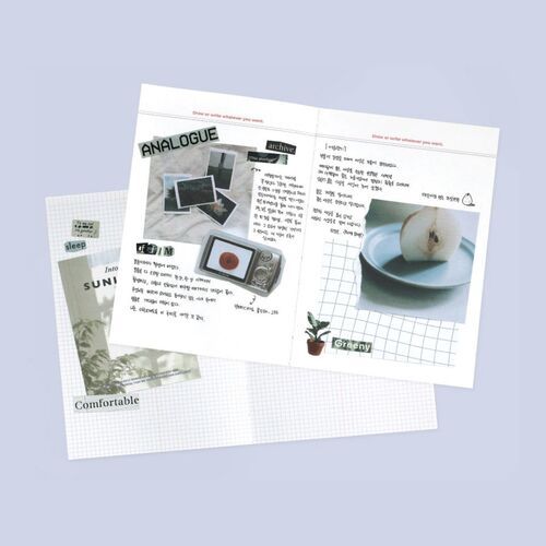Decorative journaling fills the open spread with photographs, labels, grid paper, and collage-style memory keeping.