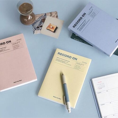 A broad display shows the planners styled as desk and shelf accessories, with the dated formats visible on several covers.