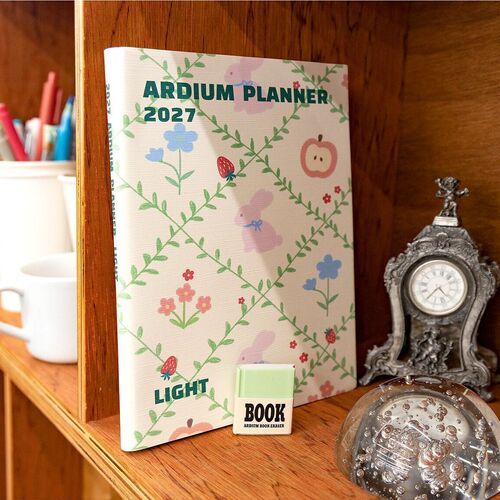 Ivory Garden stands on a shelf, showing its decorative cover as part of an organized workspace.