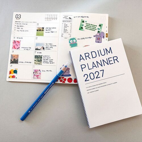 Blue Blooming and Ivory Garden are paired with an open monthly page, highlighting the planner’s clean layout and decorative covers.